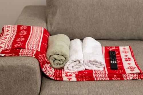 two towels on a blanket on a couch at The Forest Nest in Dealu Armanului