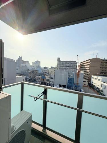 a balcony with a view of a city at Hoshino Stay 2 Near Namba 3-Min Walk to Station in Osaka