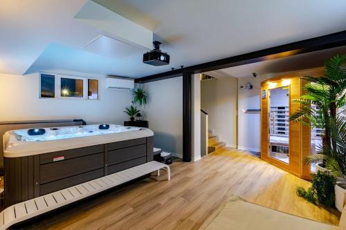 a large bathroom with a tub in the middle at Villa de rêve - Climatisation - Sauna - Spa - babyfoot - Arcade in Quatzenheim