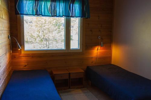 En eller flere senge i et værelse på Ounasvaara Sport Cottages