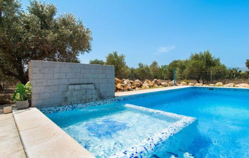 a swimming pool with a fireplace in a yard at Can Paxaco in Alcudia