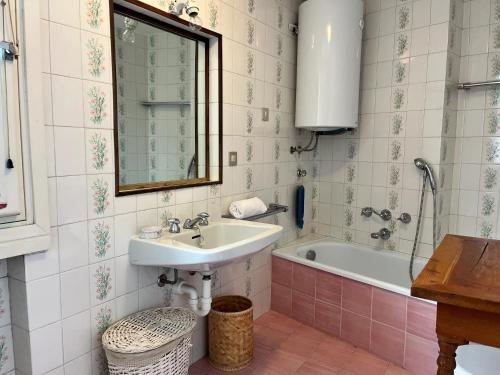 a bathroom with a sink and a bath tub at GuestHost - Il Dente del Gigante in Courmayeur
