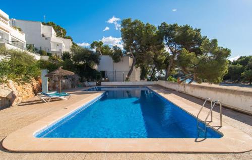 a swimming pool in a villa with trees at Playa D'or in Cala d´Or