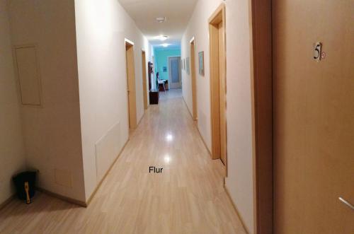 a hallway leading to a room with a hallway at Gaestehaus Remde in Erfurt