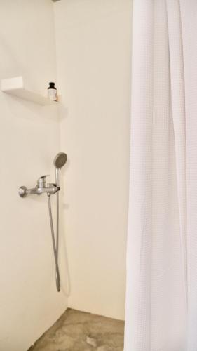 a shower in a bathroom with a shower curtain at Calliste's House in Ioulis