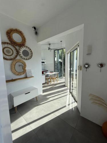 a living room with white walls and a table at Stylish villa with private pool in Koolbaai in Koolbaai
