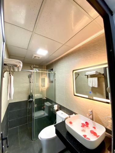 a bathroom with a toilet and a sink and a shower at My House Hotel Hanoi in Hanoi