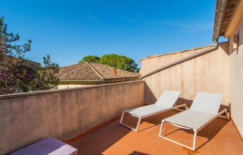 two white chairs on a balcony with a wall at C'as Pobres in Sóller