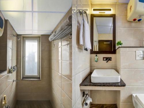 a bathroom with a sink and a mirror at Anand Bhawan in New Delhi