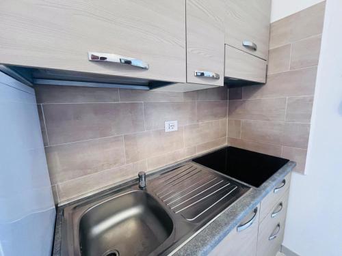 a stainless steel sink in a small kitchen at Capoliveri Lecce Home in Capoliveri