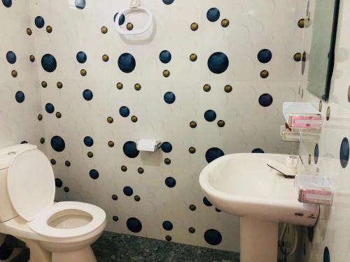 a bathroom with a toilet and a sink at Lumora Resort in Horuwila