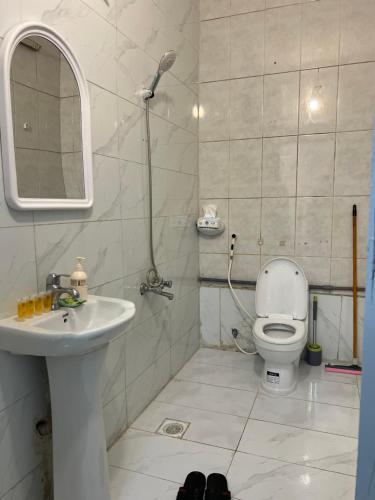 a bathroom with a sink and a toilet and a mirror at SAMA Economic Apartment in Medina