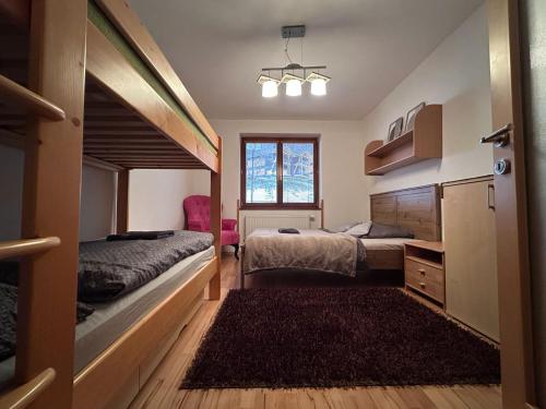 a bedroom with two beds and a window at Apartmán Donovaly 90 in Donovaly