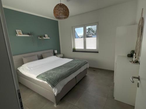 a bedroom with a bed and a window at Ferienwohnung in der wunderschönen Eifel in Dankerath