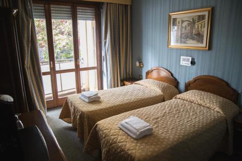 Posteľ alebo postele v izbe v ubytovaní Hotel Accursio