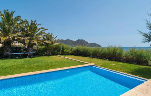 a swimming pool with a view of the ocean at Port Nou in Cala Bona