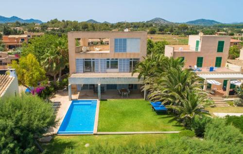 an aerial view of a house with a swimming pool at Port Nou in Cala Bona