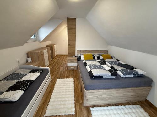 a bedroom with two beds in a attic at Chalet U Pstruha in Vimperk