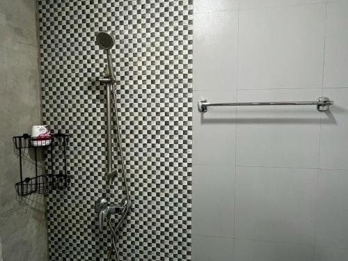 a shower with a glass door in a bathroom at Easy Loft Hostel in Phuket