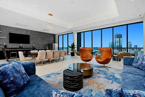 a living room with a blue couch and chairs at apartment in Tryp by Wyndham near broadwater in Gold Coast