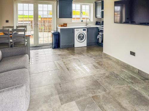 a kitchen with a washer and dryer in a room at Cleveland View Cottage in North Cowton