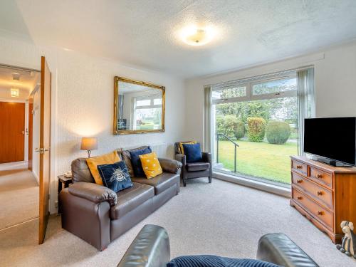 a living room with a couch and a television at The Mulberry in Lamlash