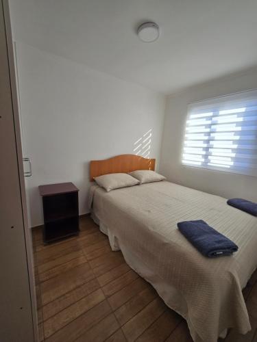 a bedroom with a large bed and a window at Alto La Florida Cabañas in Huasco