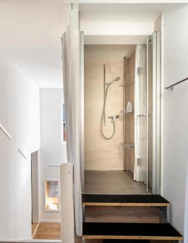 a bathroom with a shower and a walk in shower at Central City Apartment 2 with Mountain View in Zweisimmen