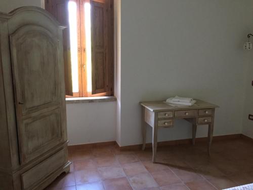 a room with a wooden table and a window at Locanda Marzi in Faicchio
