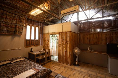 a bedroom with a bed and a desk and a sink at Lagom Village-Sweet Home- Đồng Đò lake in Hanoi