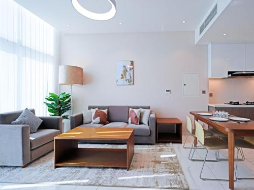 a living room with a couch and a table at Elegant 1-Bedroom Apartment in Al Furjan-710 in Dubai