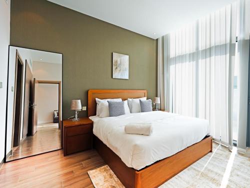 a bedroom with a large bed and a large window at Elegant 1-Bedroom Apartment in Al Furjan-710 in Dubai