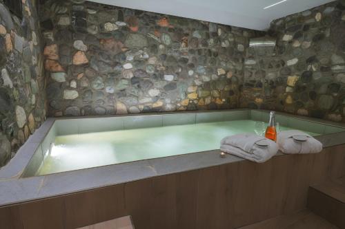 a bath tub with towels sitting on top of it at Alkyonis Hotel & Spa in Kato Loutraki