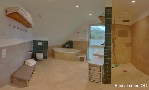 a bathroom with a tub and a sink and a shower at Ferienhaus Sonne in Göhren-Lebbin