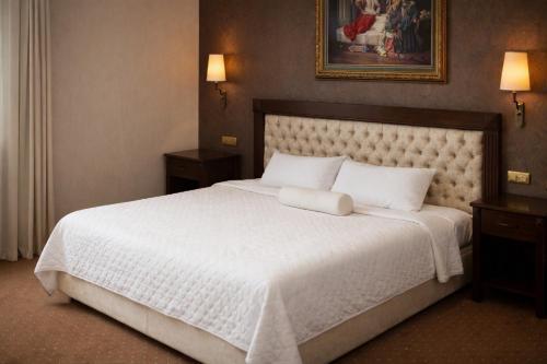 a bedroom with a large bed with a white bedspread at Akgün Hotel Laleli Istanbul in Istanbul