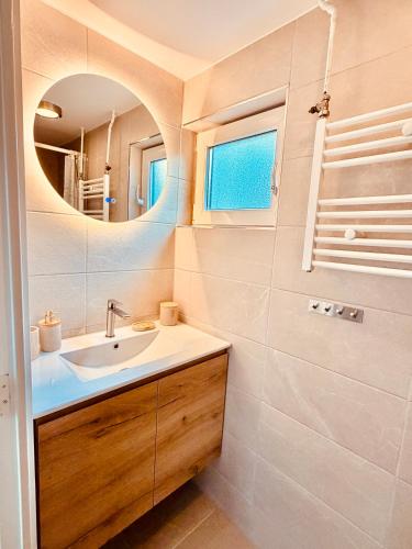 a bathroom with a sink and a mirror at Beach House Sea-Esta in Egmond aan Zee