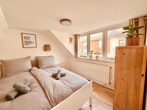 a bedroom with a bed with two teddy bears on it at Beach House Sea-Esta in Egmond aan Zee