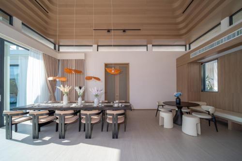 a dining room with a table and chairs at Étoile Kata Luxury Pool Villas by Astra in Kata Beach