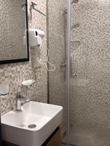 a bathroom with a sink and a shower at Gоderdzi Twins Hotel in Goderdzi