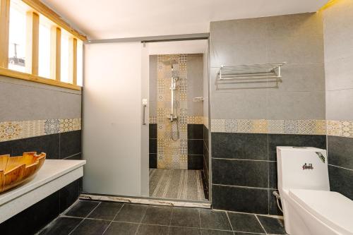 a bathroom with a shower and a toilet and a sink at YISHUYIHUACoFFee Hotel in Zhangjiajie