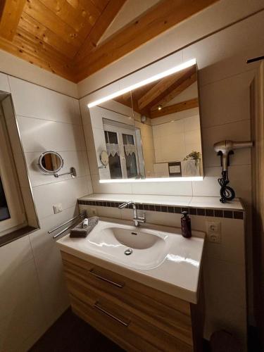 a bathroom with a sink and a mirror at Ferienhaus Fichtelwichtel in Mehlmeisel