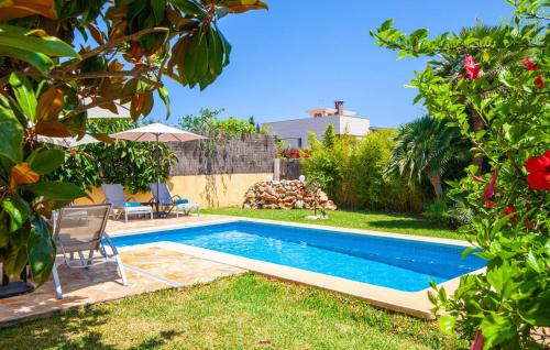 a swimming pool in the backyard of a house at Mirte in Sa Coma