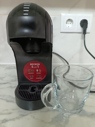 a coffee maker and a glass cup on a counter at Adelaide's Cottage in Ponta do Pargo