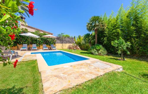 a swimming pool in the yard of a house at Mirte in Sa Coma