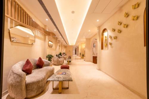 a long hallway with couches and a table at Sterling Saryu Ayodhya in Ayodhya