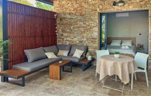 a patio with couches and a table and a table and chairs at Très Beau Gîte Piscine - Spa in Solliès-Pont