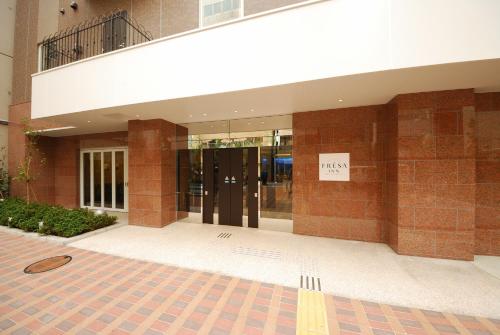 a building with a sign on the side of it at Sotetsu Fresa Inn Hamamatsucho-Daimon in Tokyo