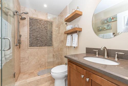 a bathroom with a toilet and a shower and a sink at Charming 2Br Condo W Ac, Steps To Beach And Balboa Pier By Beachview Rentals in Newport Beach