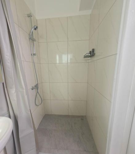 a bathroom with a shower with a toilet and a sink at Athalassas corner in Strovolos