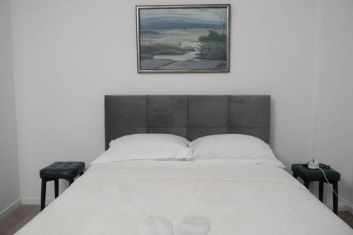a bedroom with a bed with a picture on the wall at Athalassas corner in Strovolos